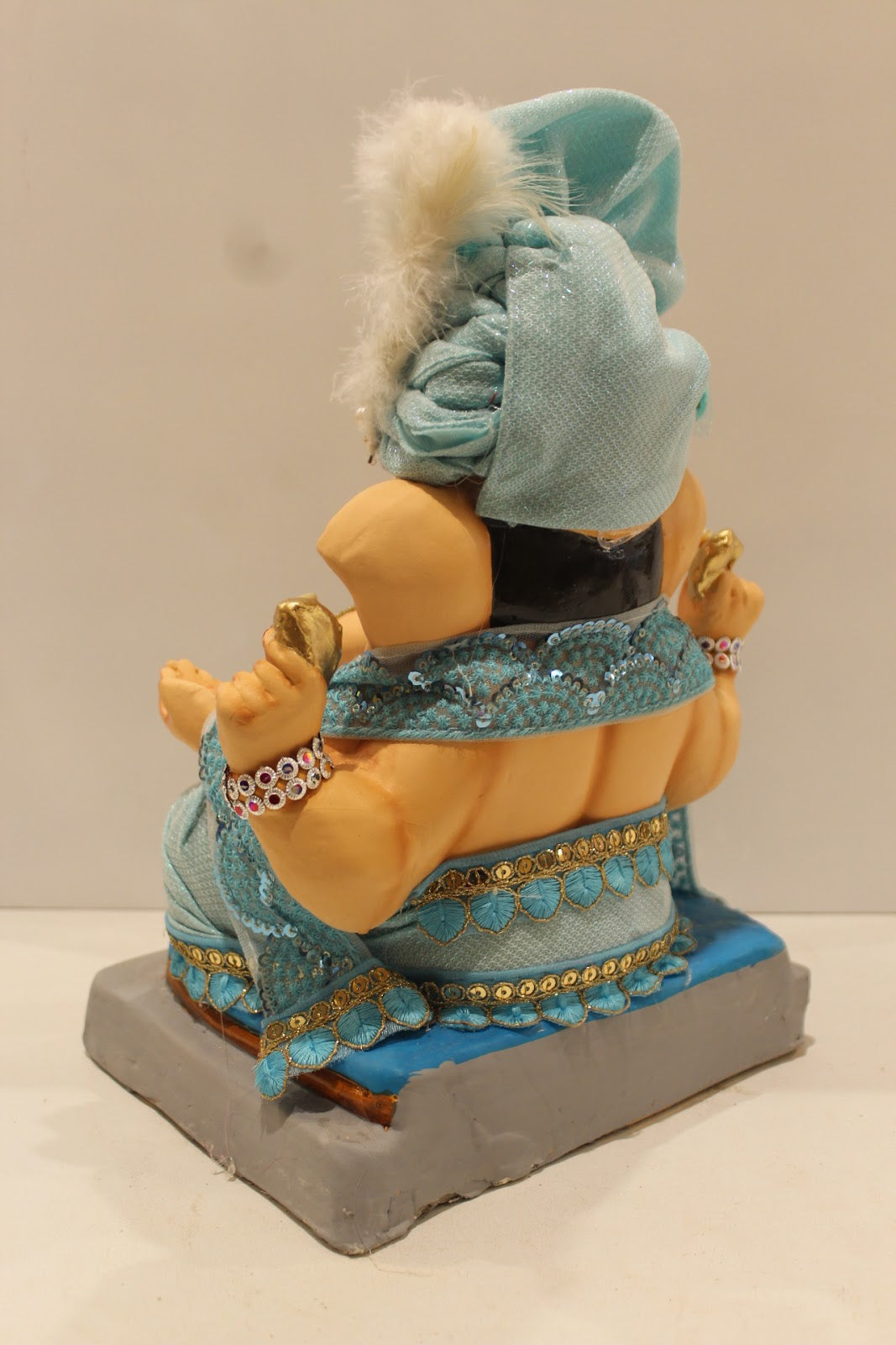 Eco-friendly clay Ganesh idol with sky blue safa and pearls, back view