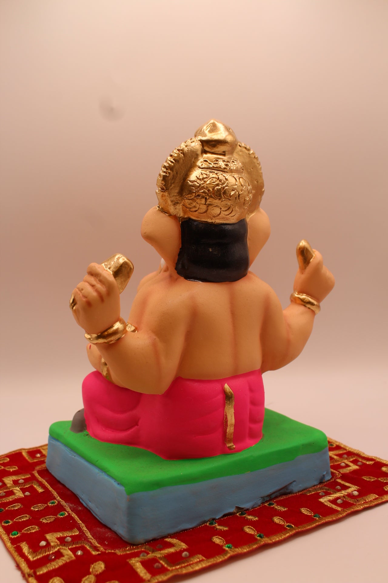 Eco-friendly 8 inch Ganesh Visarjan idol with gold fan crown and rani pink dhoti – back view