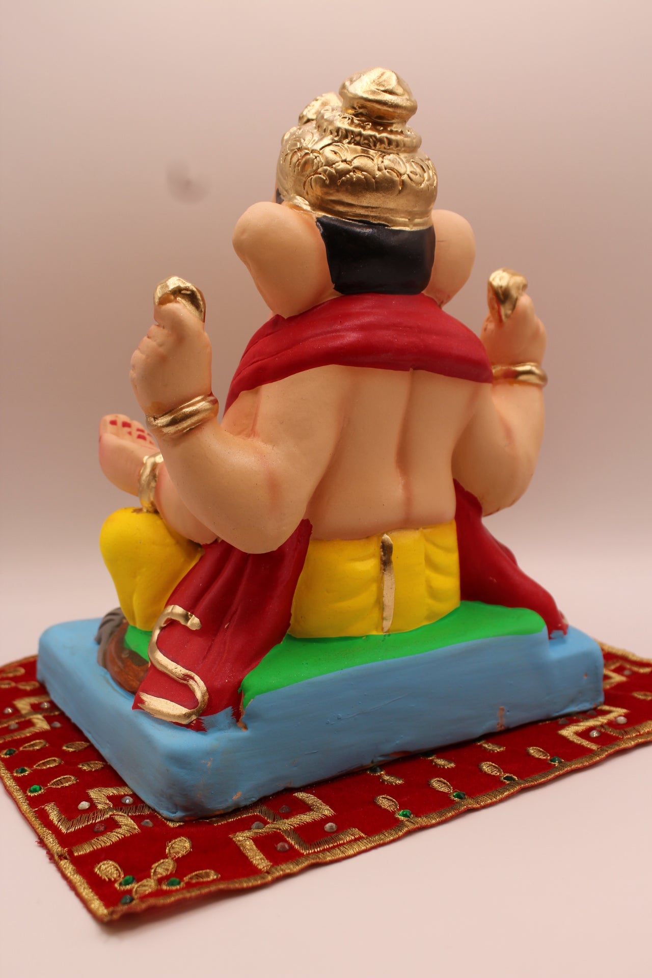 Eco-friendly 8 inch Ganesh Visarjan idol in red khes and yellow dhoti – back view