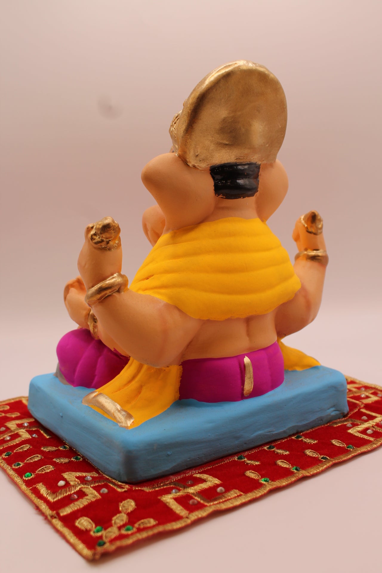 Eco-friendly 8 inch Ganesh Visarjan idol in yellow shawl and magenta dhoti – back view
