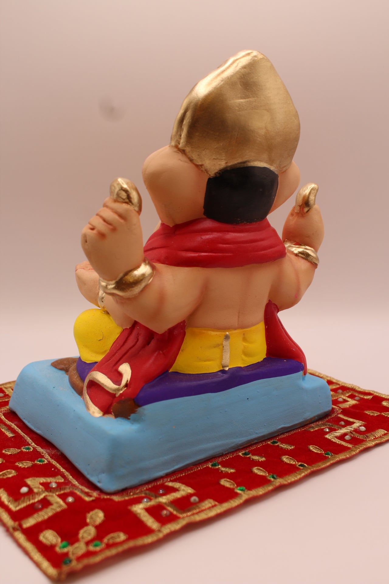 Eco-friendly 8 inch Ganesh Visarjan idol in red blouse and yellow dhoti – back view