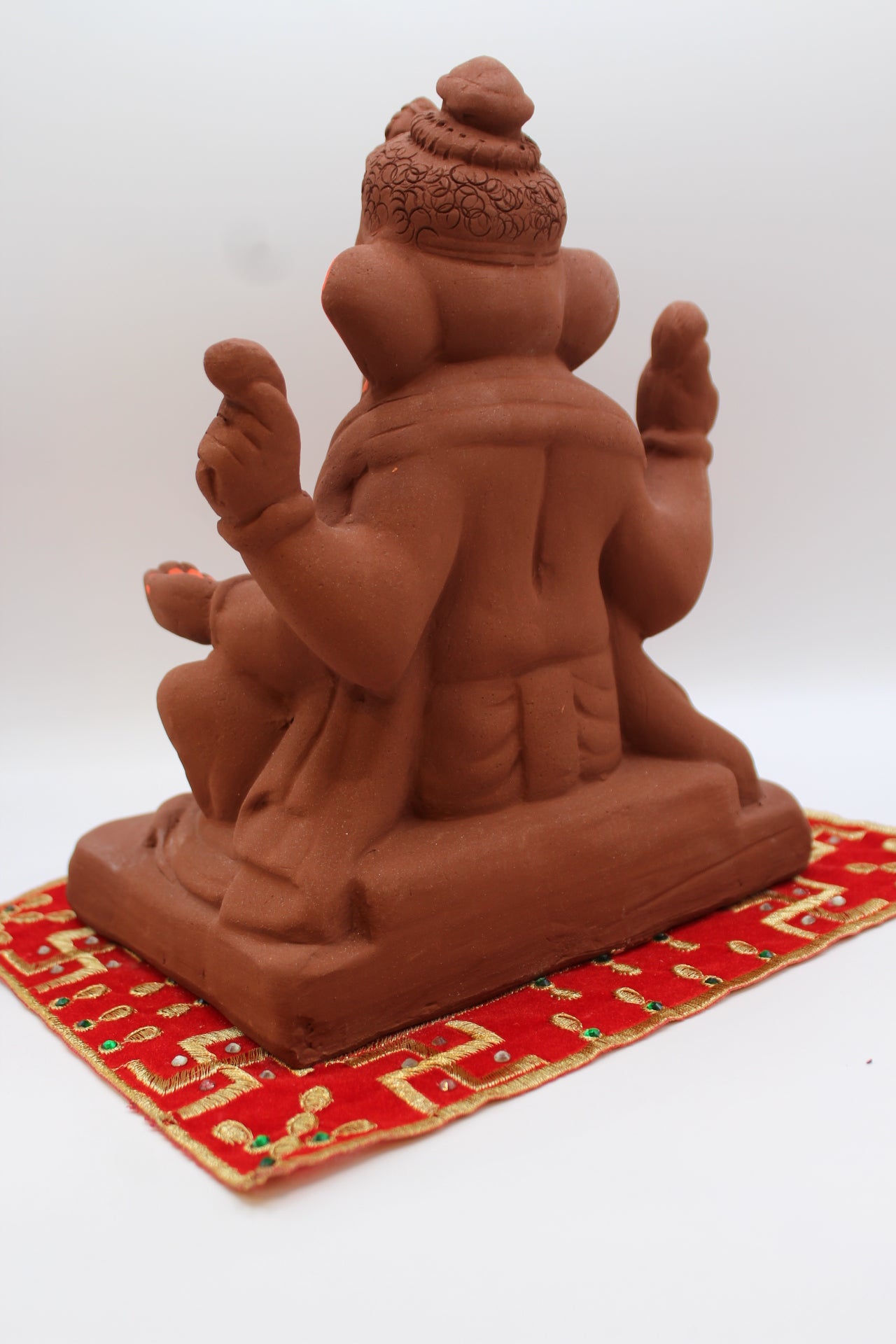 Natural terracotta eco-friendly 8 inch Ganesh Visarjan idol with bun topknot – back view