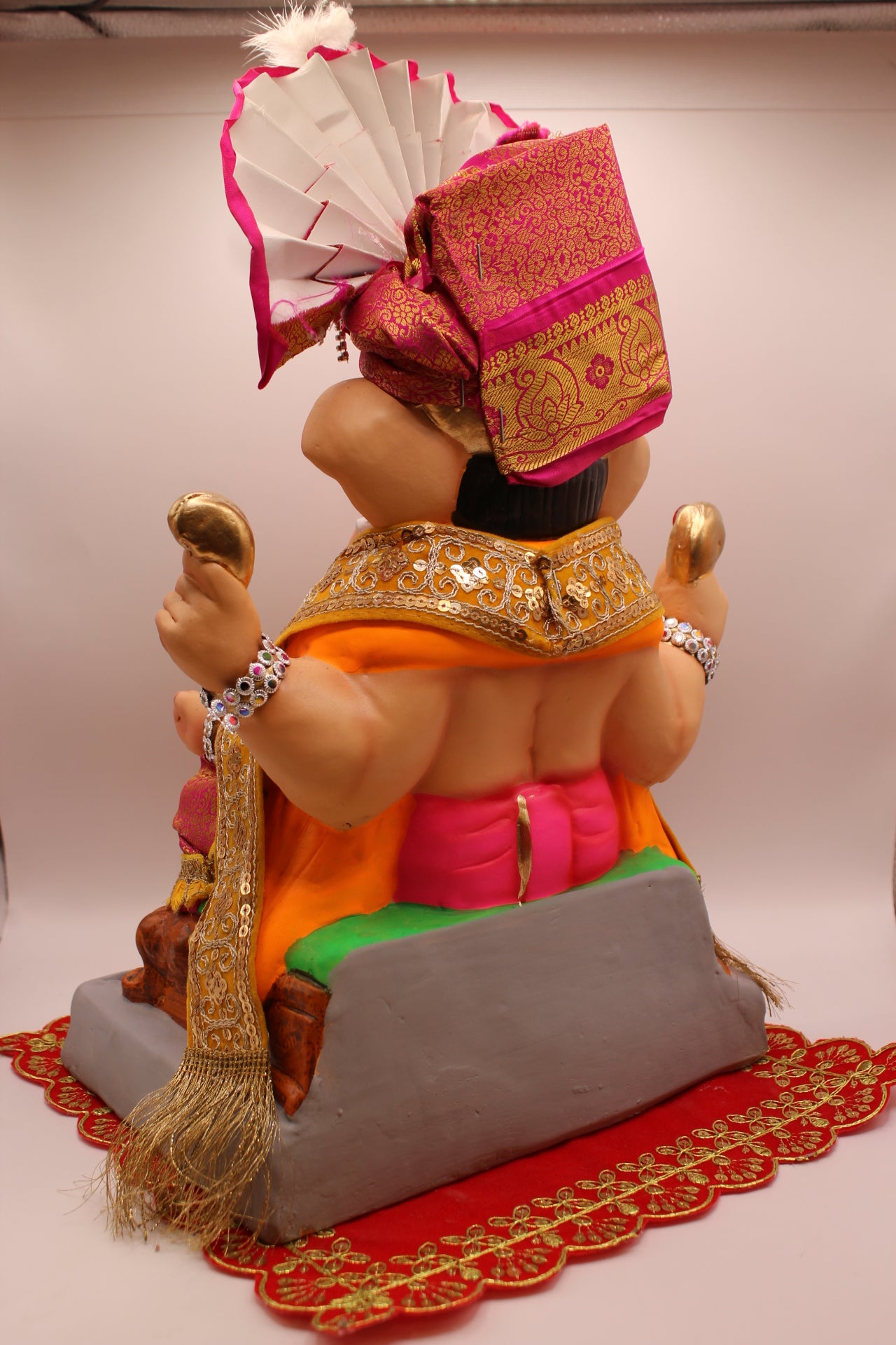 Back view – rani pink safa with gold shawl and maroon dhoti