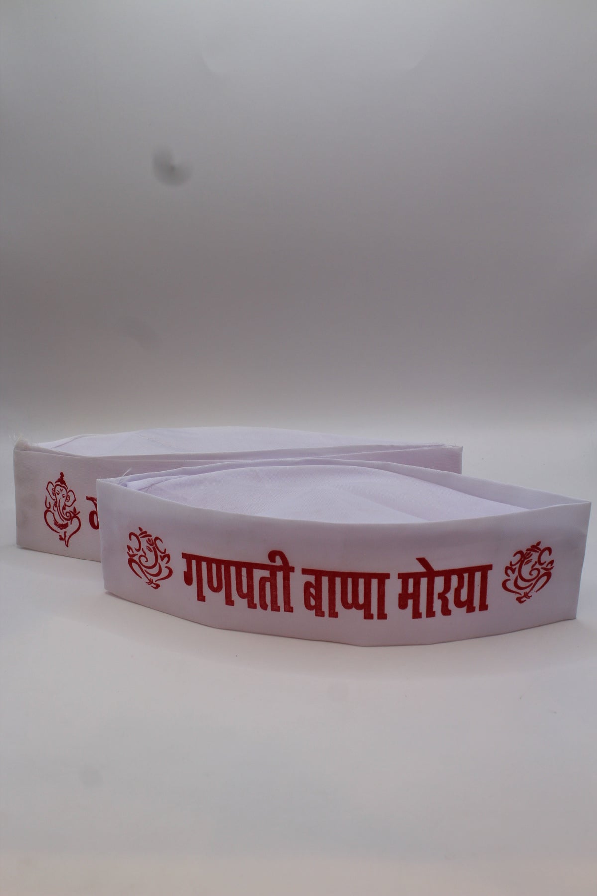 Gandhi topi with Ganpati Bappa Morya print, close-up of lettering