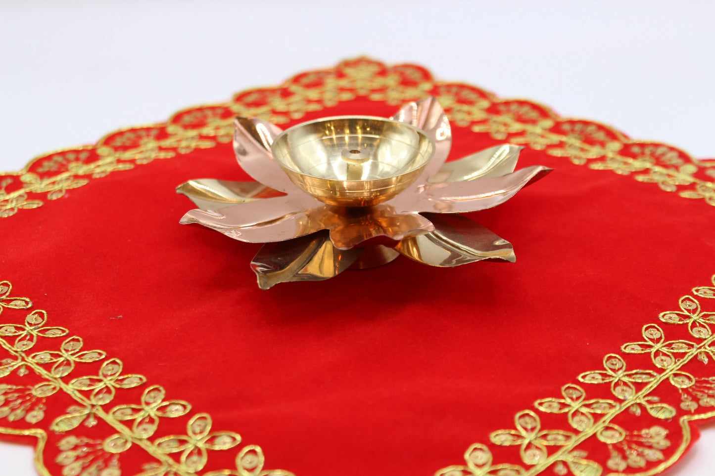 Lotus diya with alternating brass and copper petals around a deep oil well