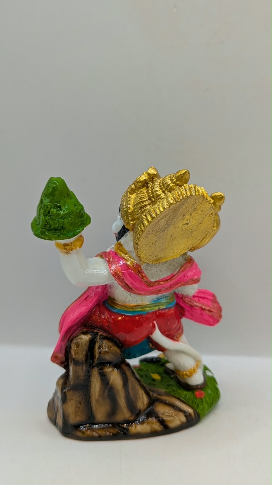 Colourful Hanuman statue with mountain and mace, back view