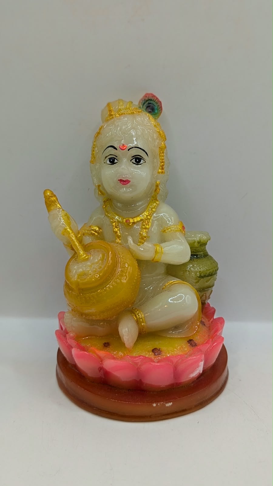 Laddu Gopal baby Krishna statue on pink lotus, back view