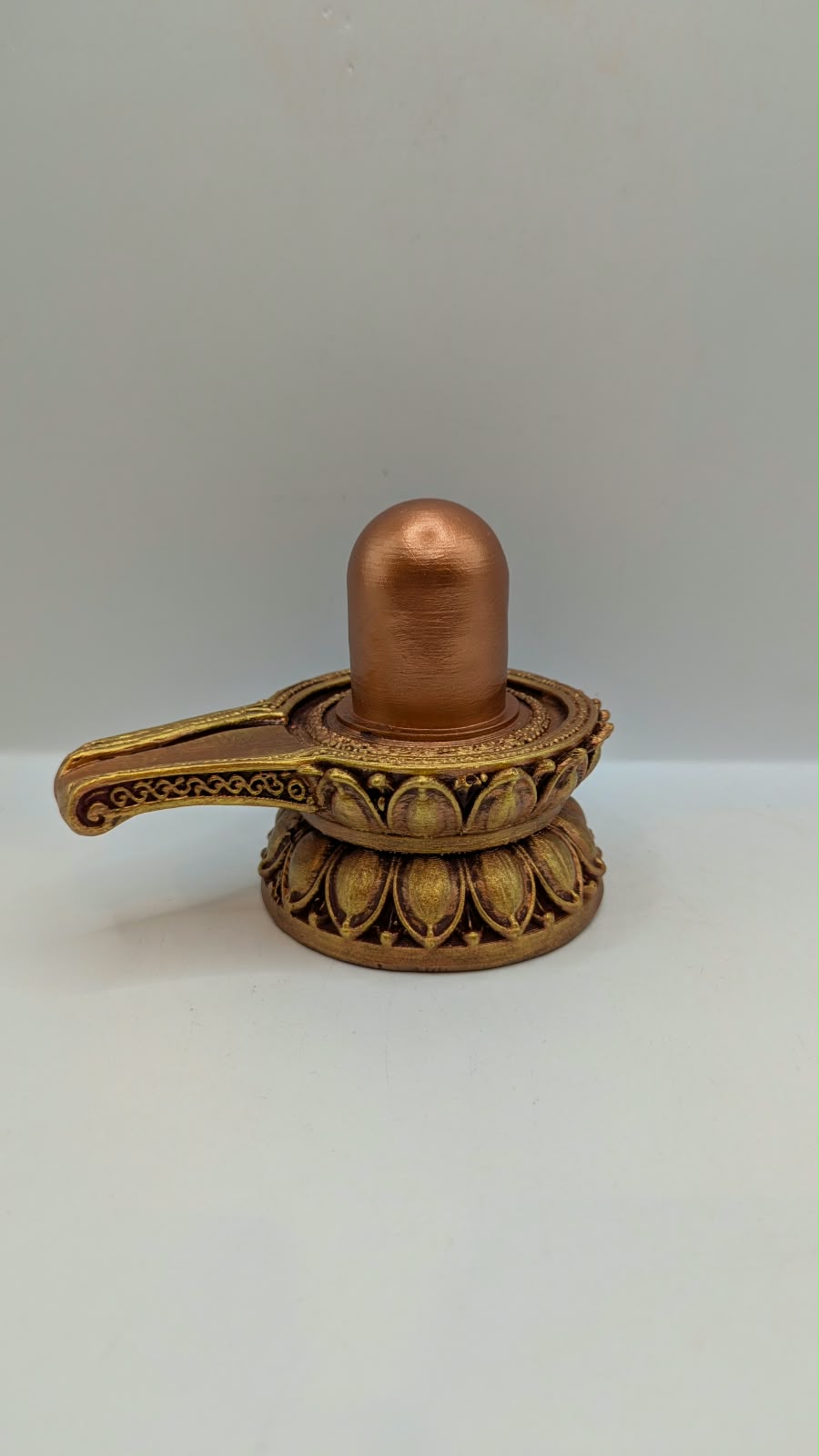 Small copper and gold Shivling statue, back view