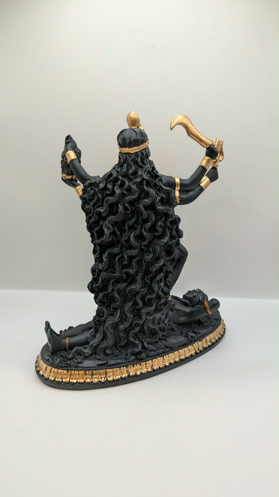 Black and gold Kali Maa statue, back view