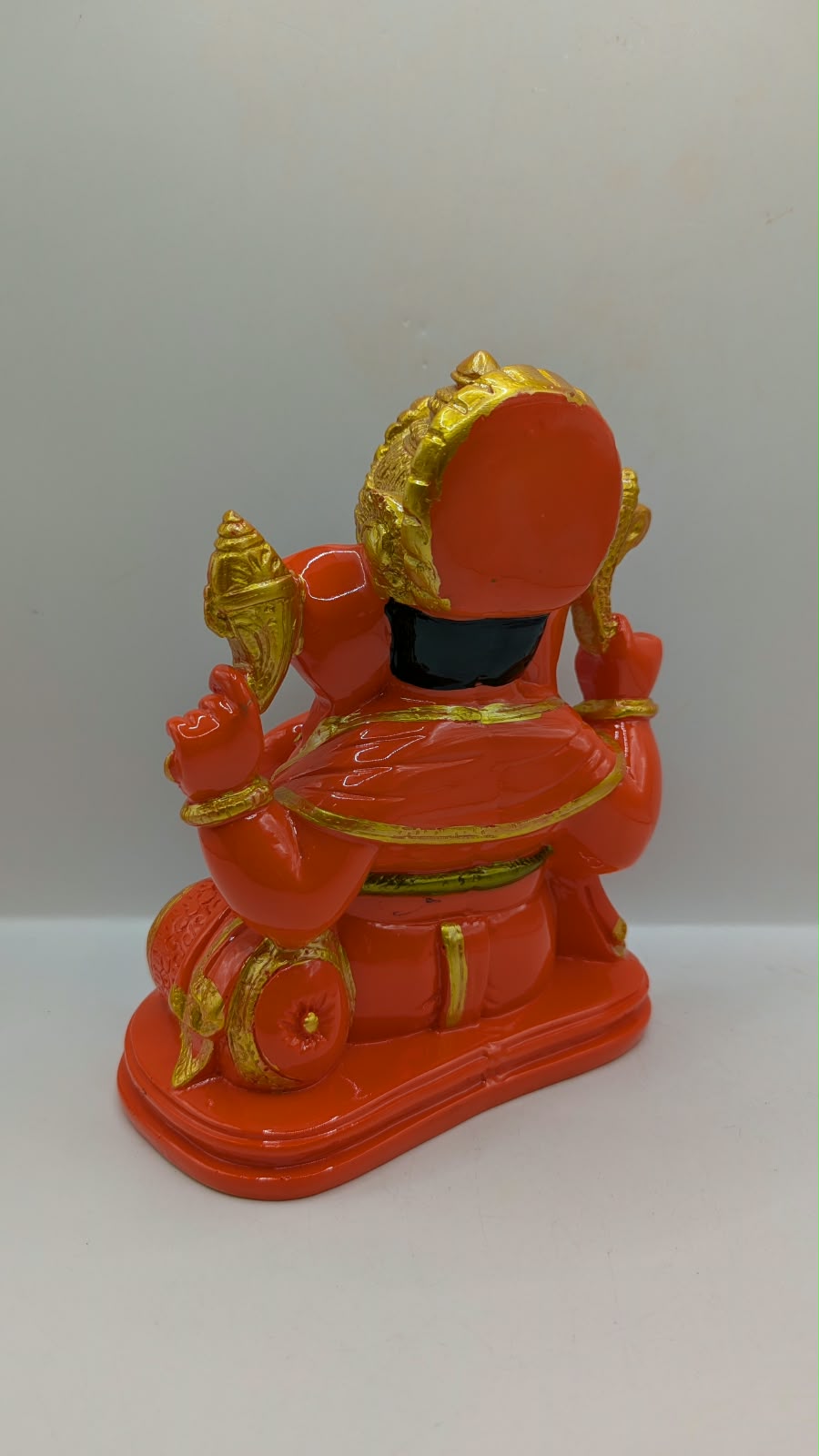Orange and gold Ganesh statue, back view