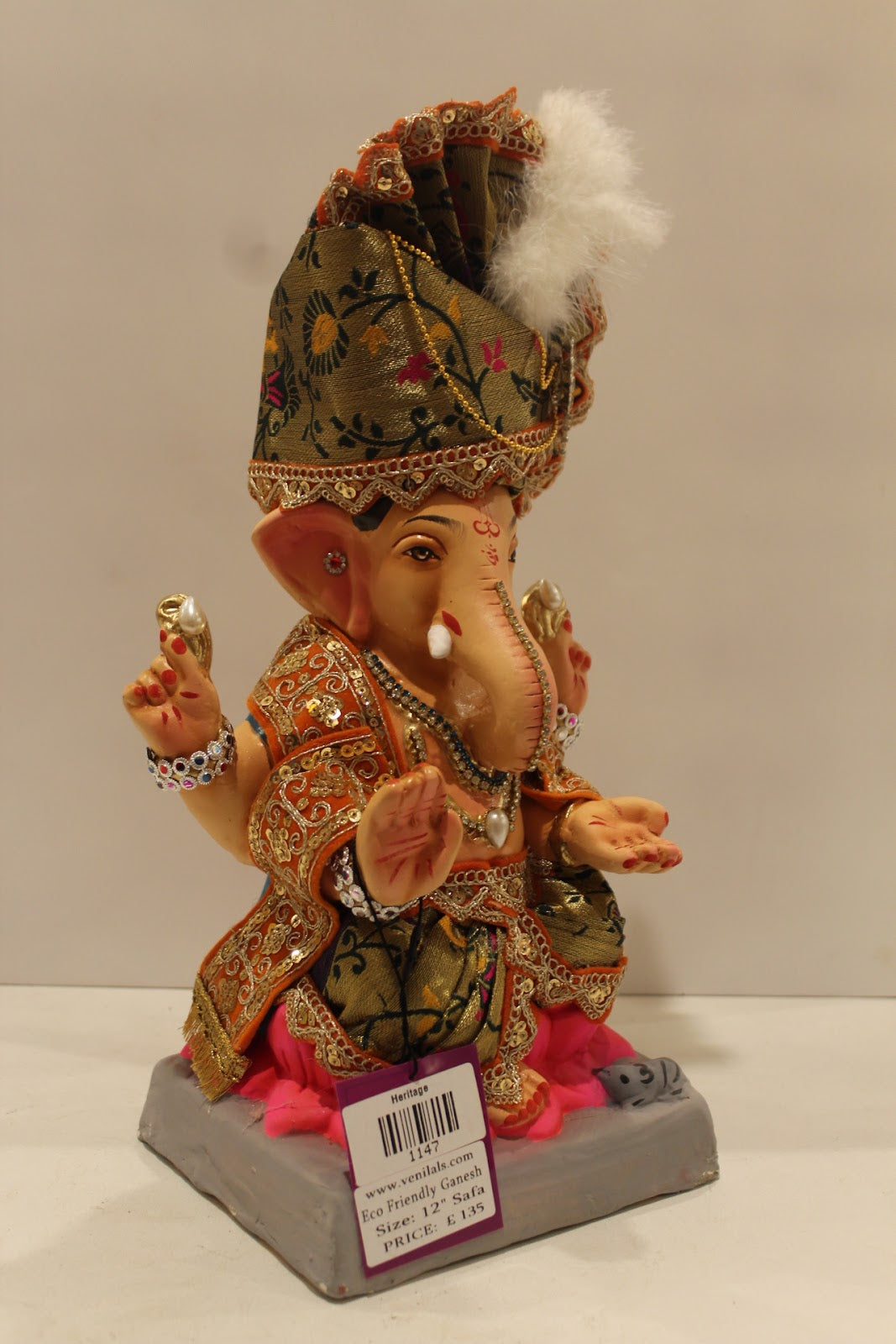 Eco-friendly clay Ganesh idol with green brocade safa and pink dhoti, side view
