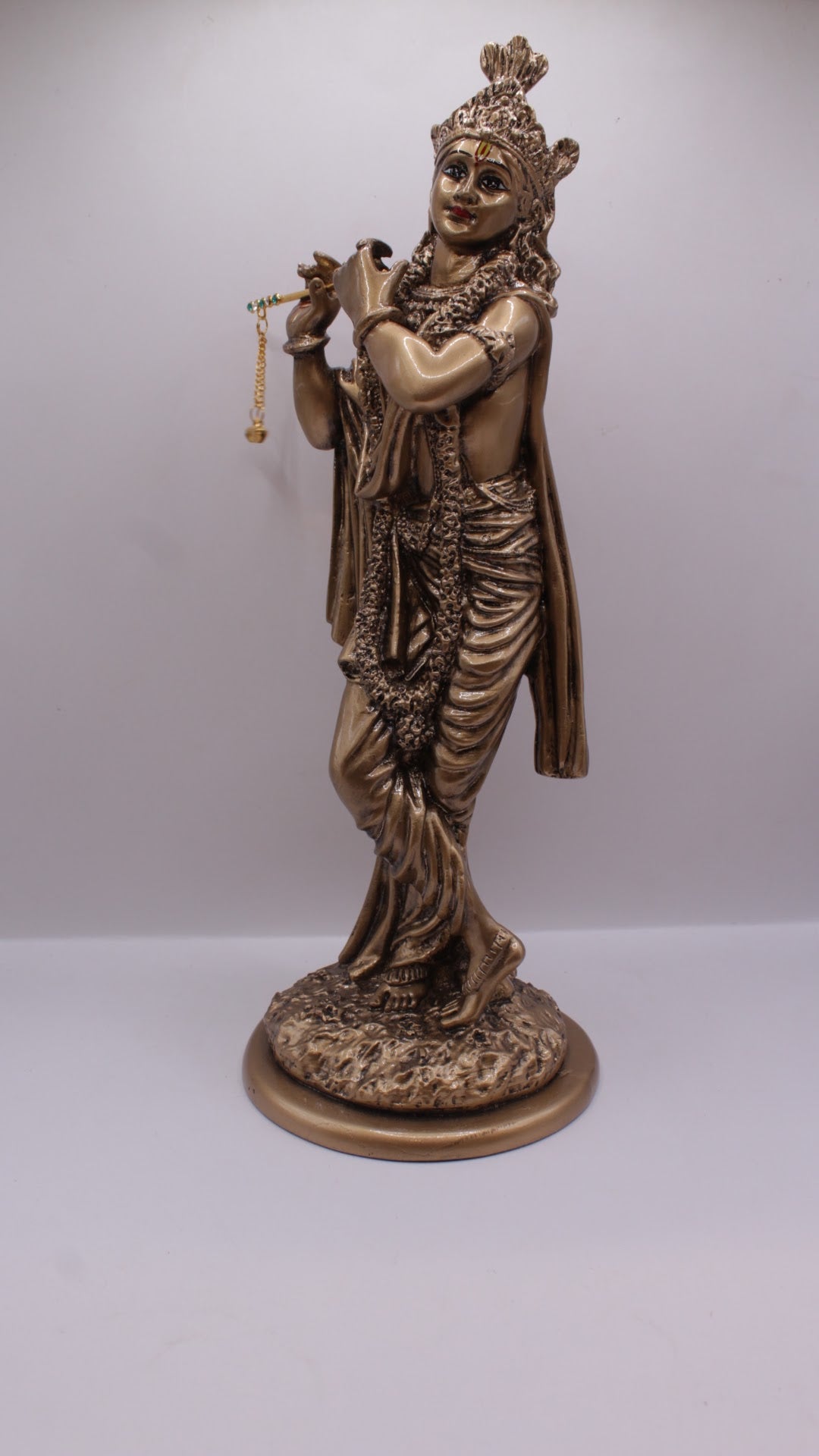 Antique bronze resin Krishna statue playing flute, right side view