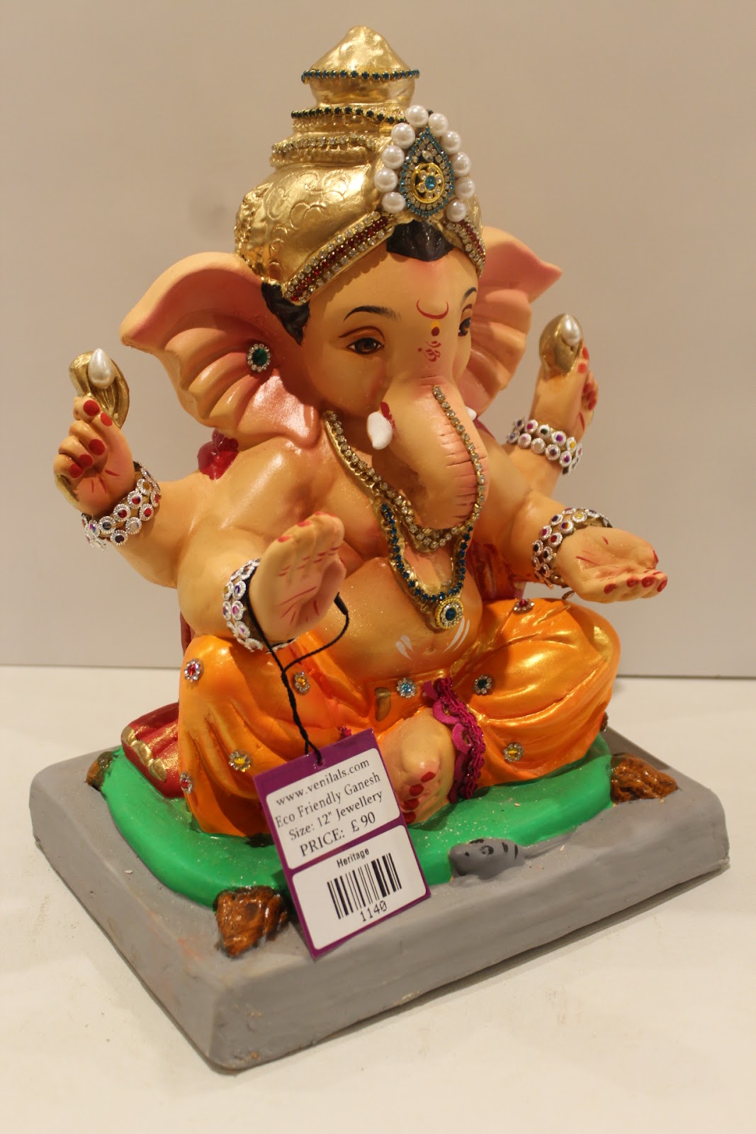 Eco-friendly clay Ganesh idol in jewellery style with pearl and teal crown, side view