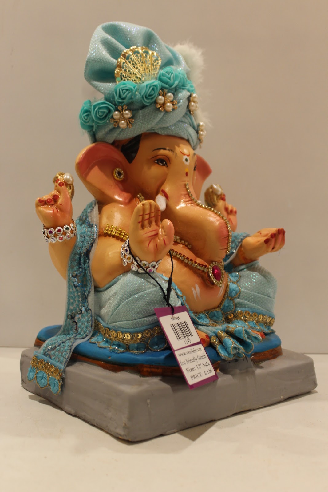 Eco-friendly clay Ganesh idol with sky blue safa and pearls, side view