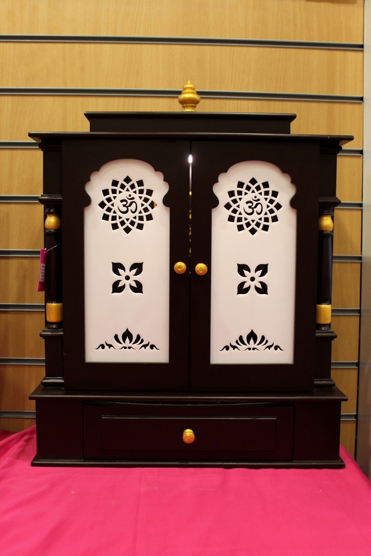 Dark rosewood wooden mandir with Om jali doors closed