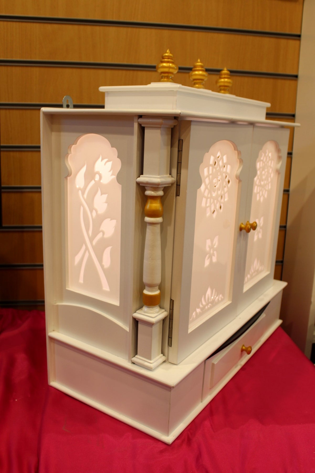 Angled view of the ivory mandir showing jali side panel
