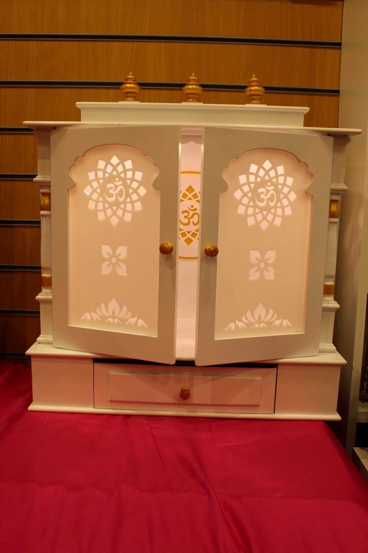 Ivory mandir with doors open and turned pillars visible
