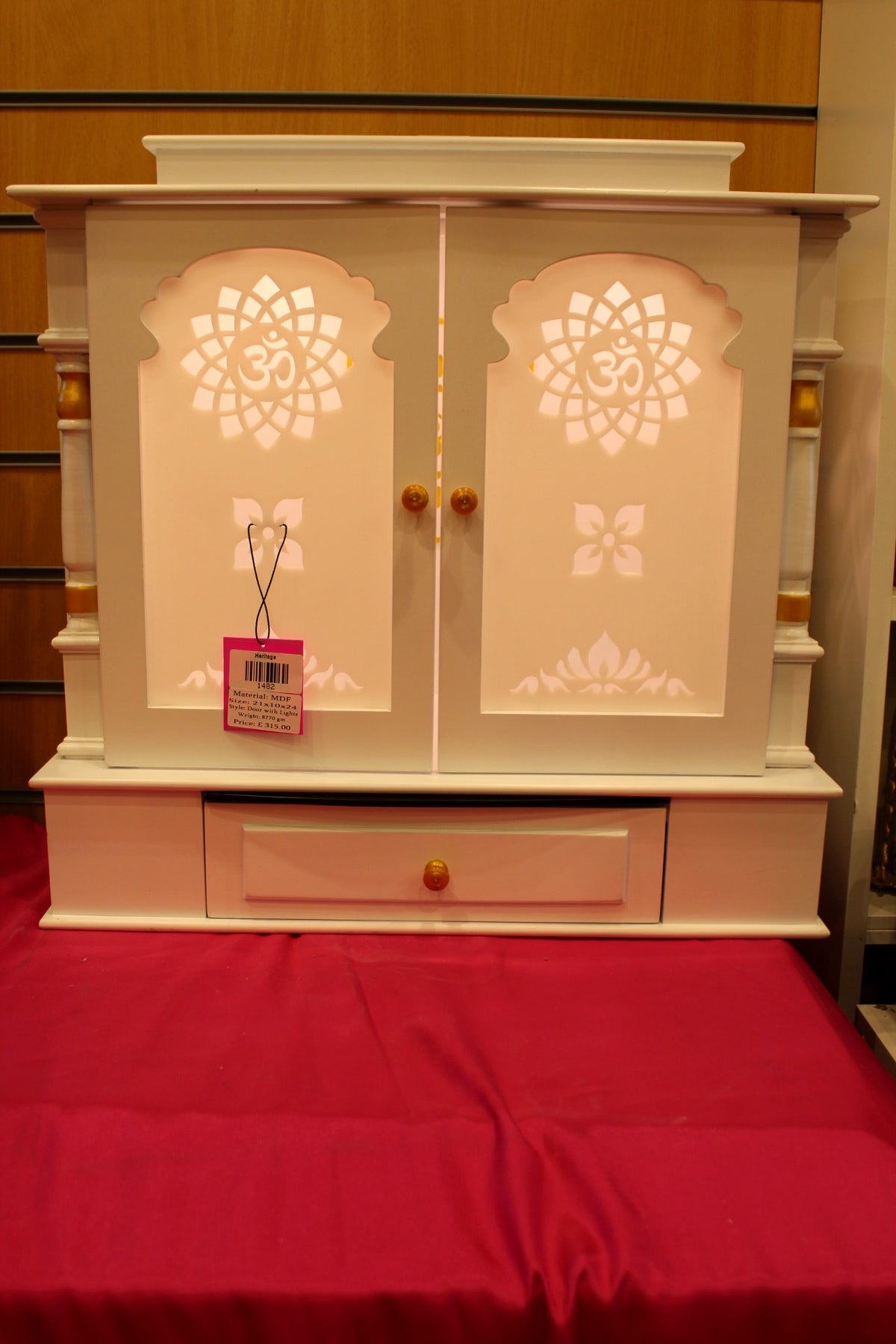 Ivory wooden mandir with Om jali doors closed