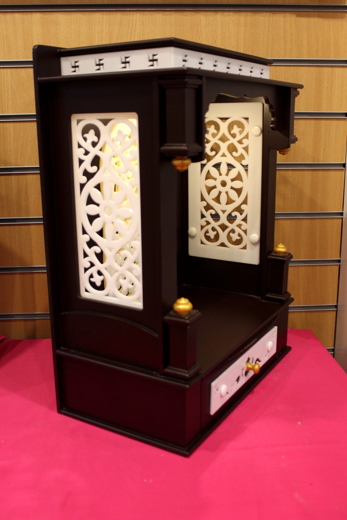 Open mandir with interior lighting switched on, illuminated niche