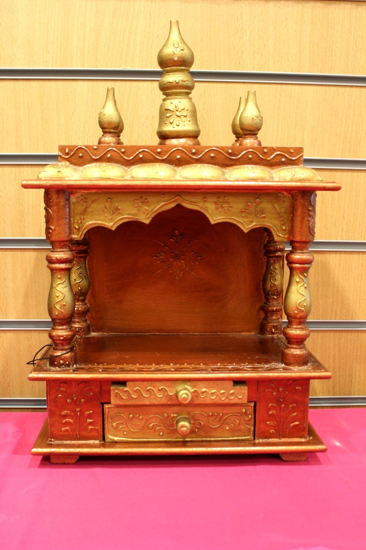 Small carved Jaipuri mandir with gold kalash domes, front view