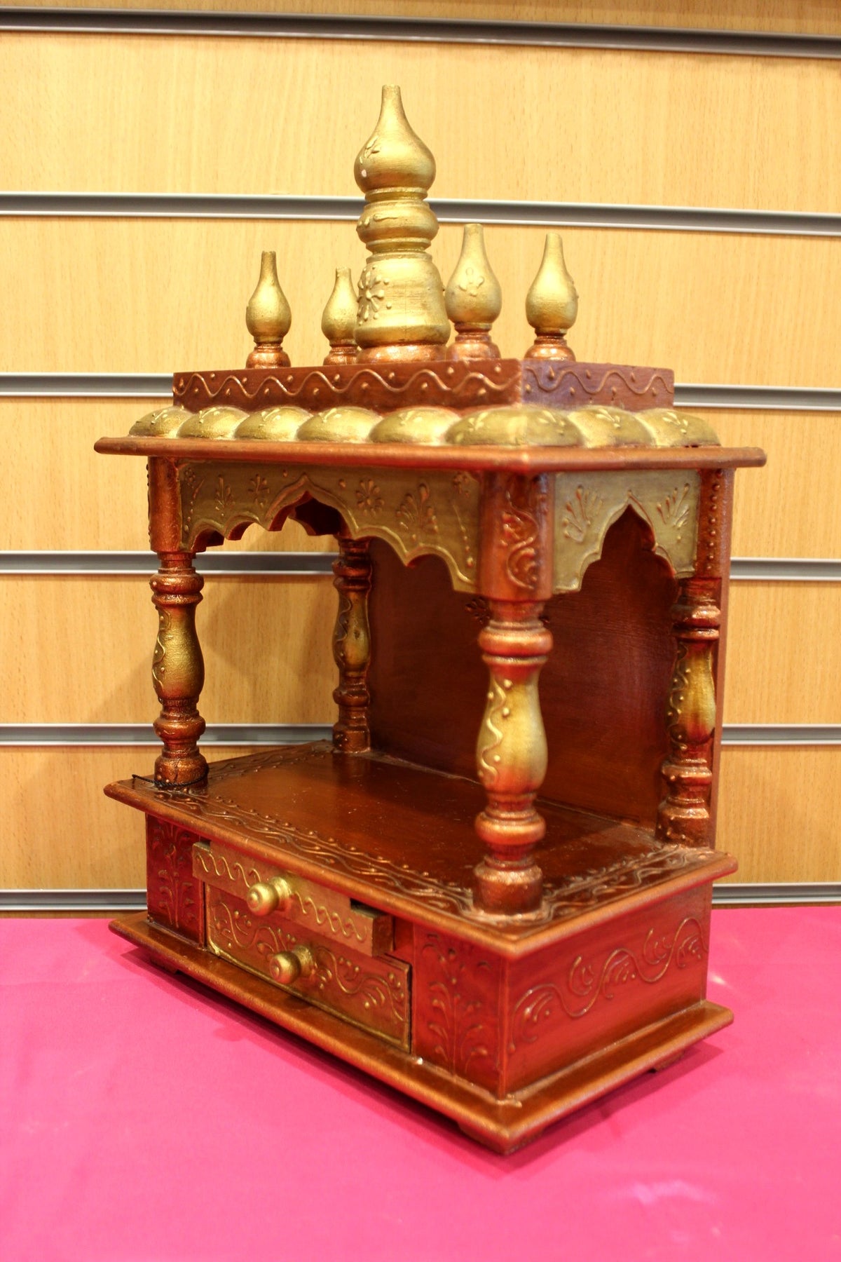 Close-up of gold domes and decorated pediment on the mandir