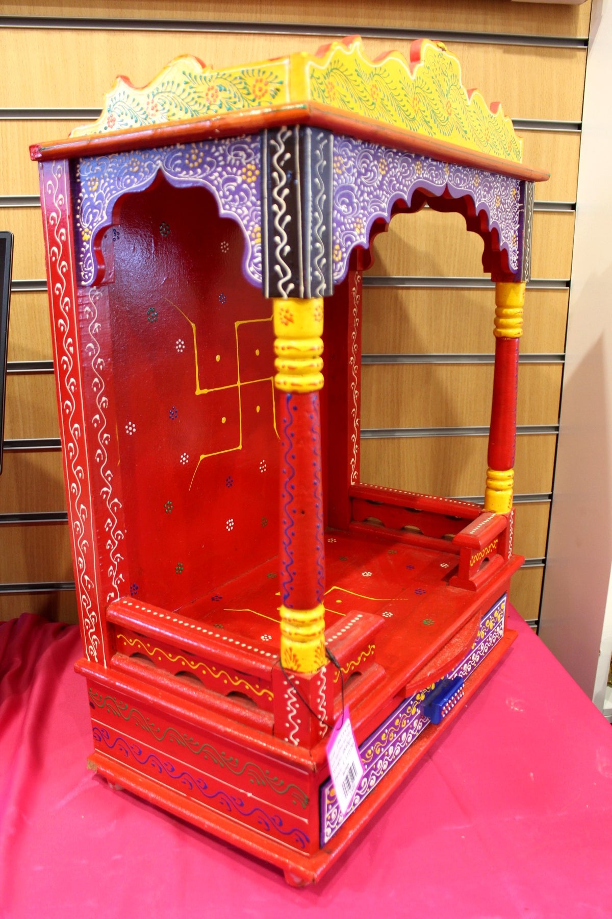 Large hand-painted red Jaipuri mandir with yellow canopy, front view