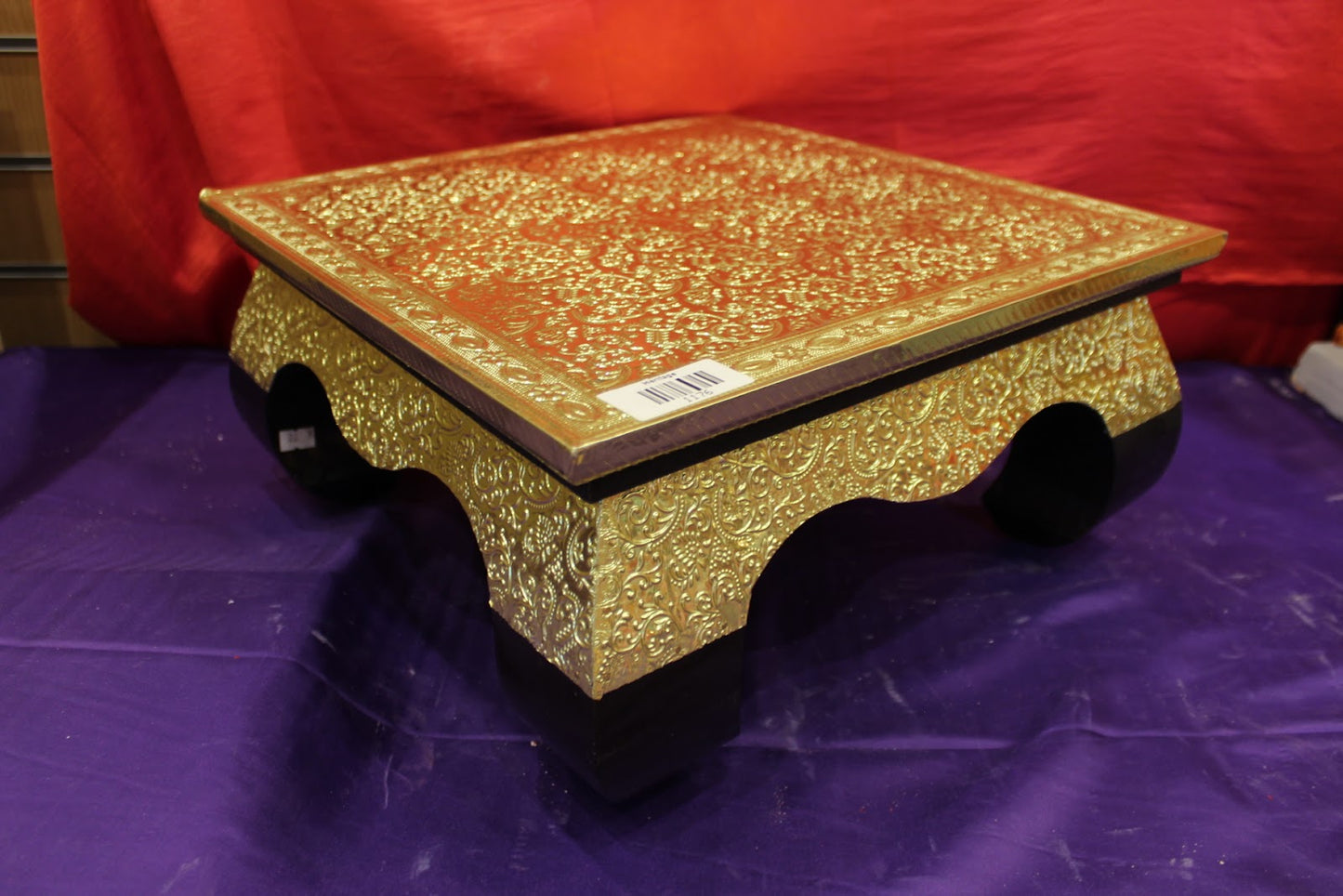 Premium gold embossed bajot pooja chowki angled view with black feet