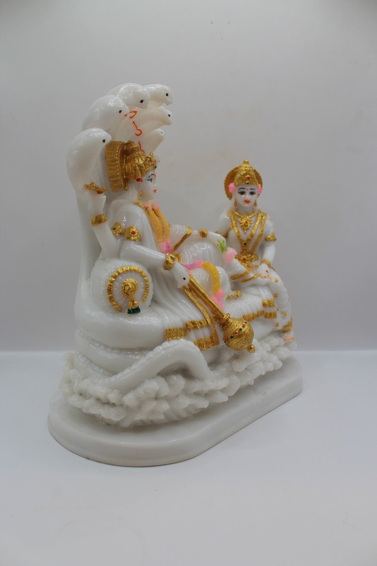 White and gold resin Vishnu Laxmi murti on Sheshnaag, left side view