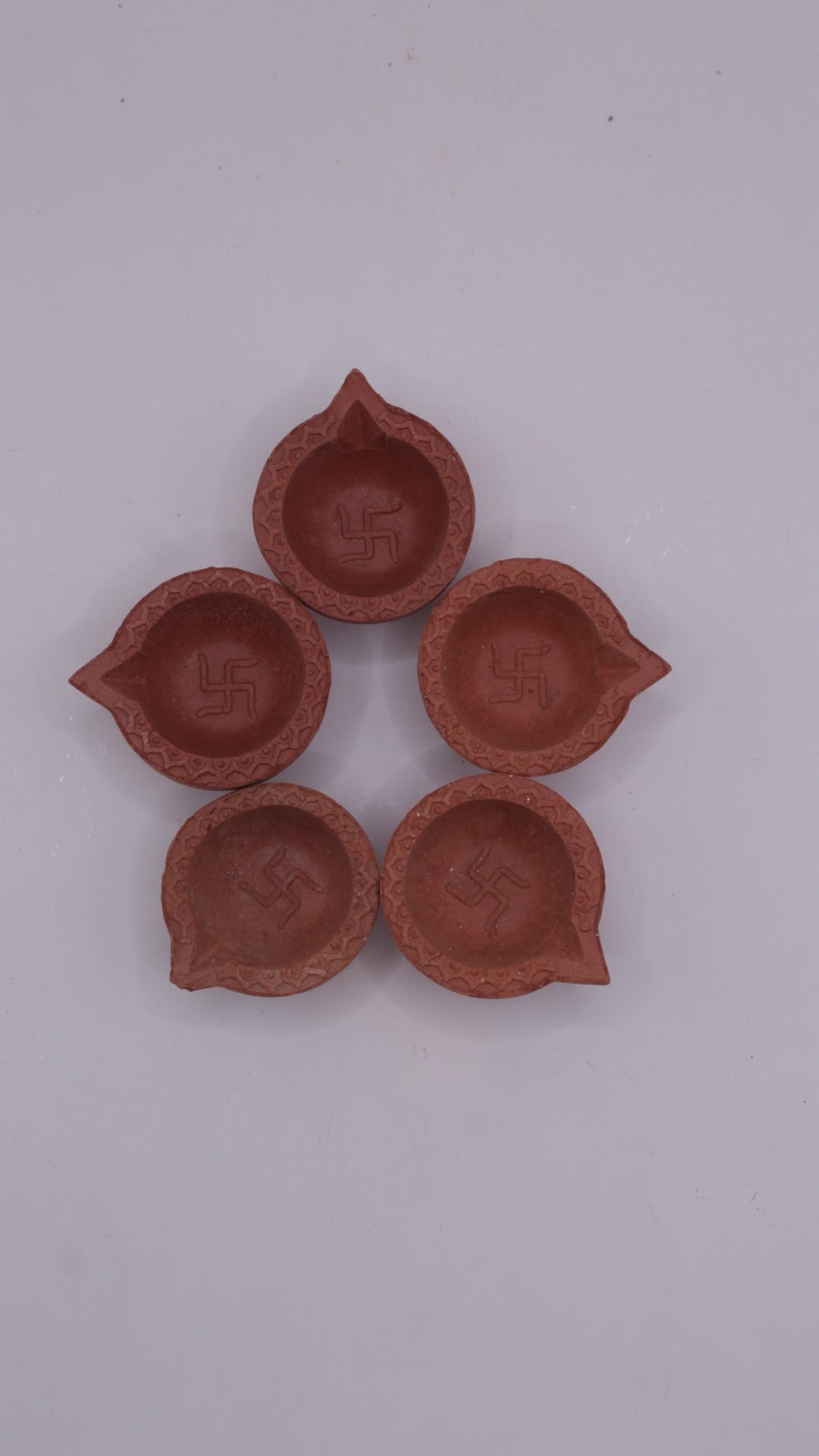 Plain clay diyas, front