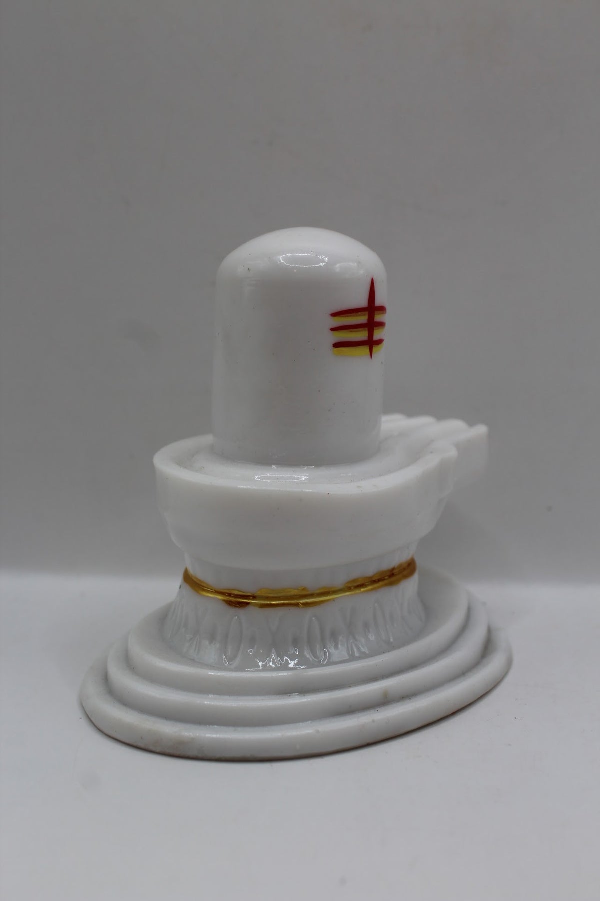 White resin Shivling with tripundra, left side view