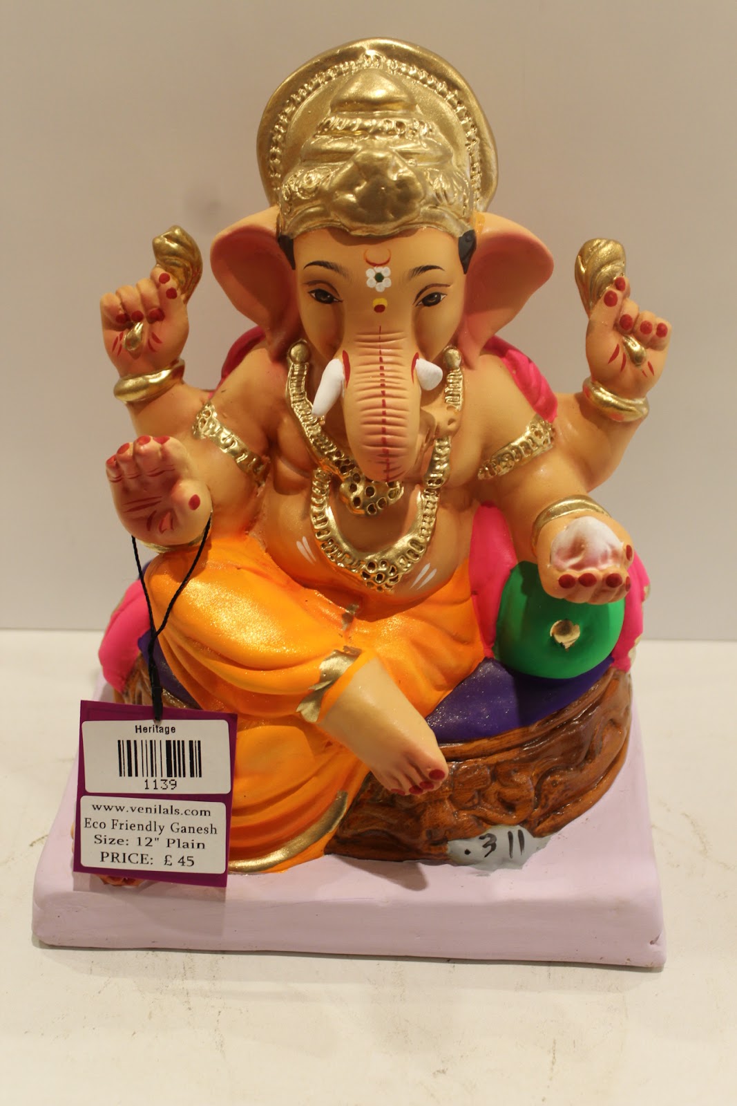 Eco-friendly clay Ganesh idol with pink khes, orange dhoti and basket throne, back view