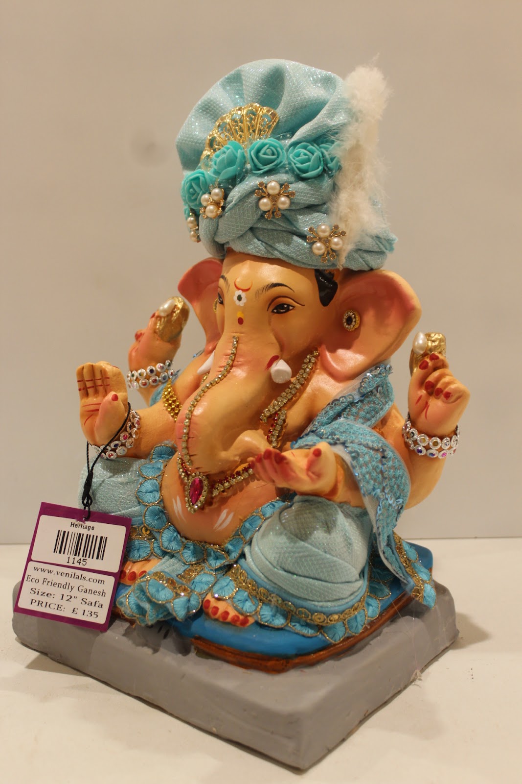 Eco-friendly clay Ganesh idol with sky blue safa and pearls, side view