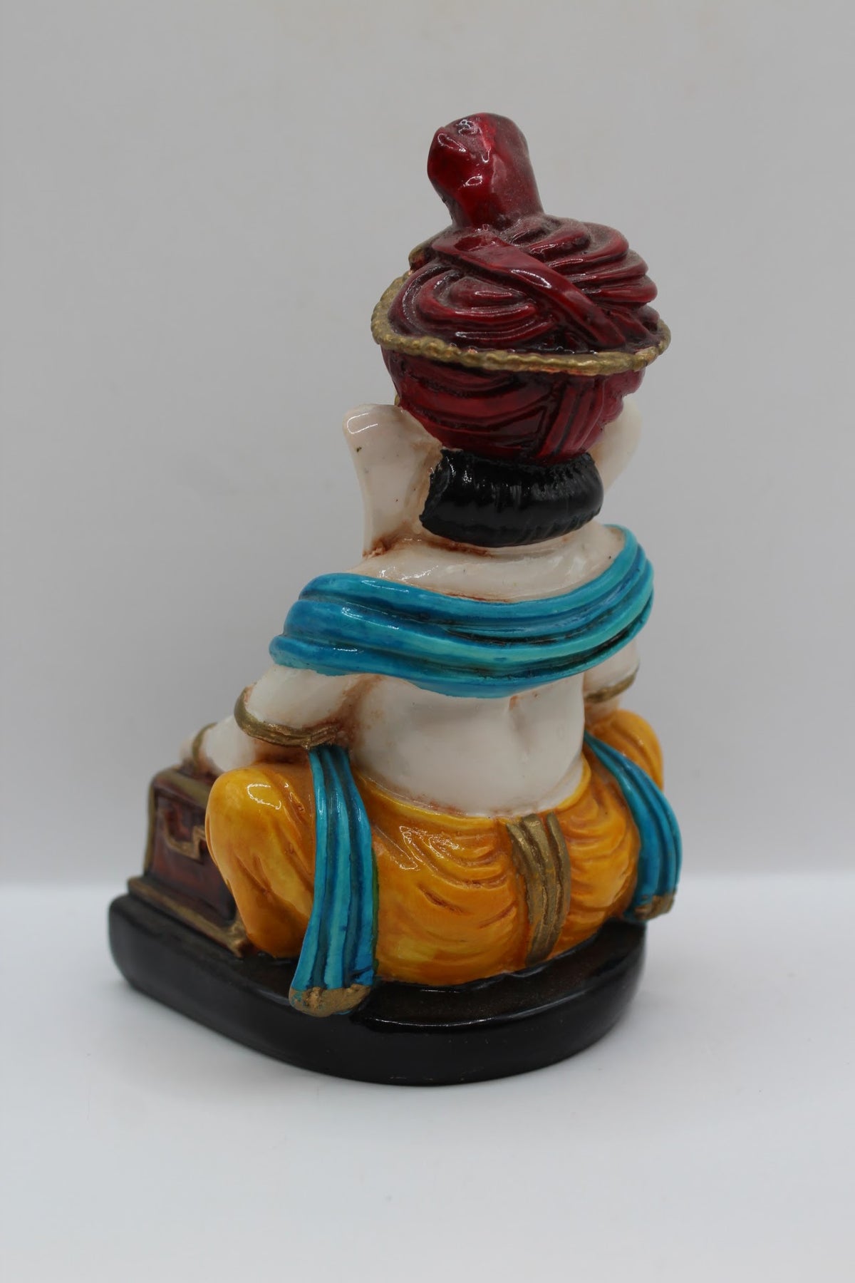 Resin Ganesh murti playing harmonium, red turban, back view