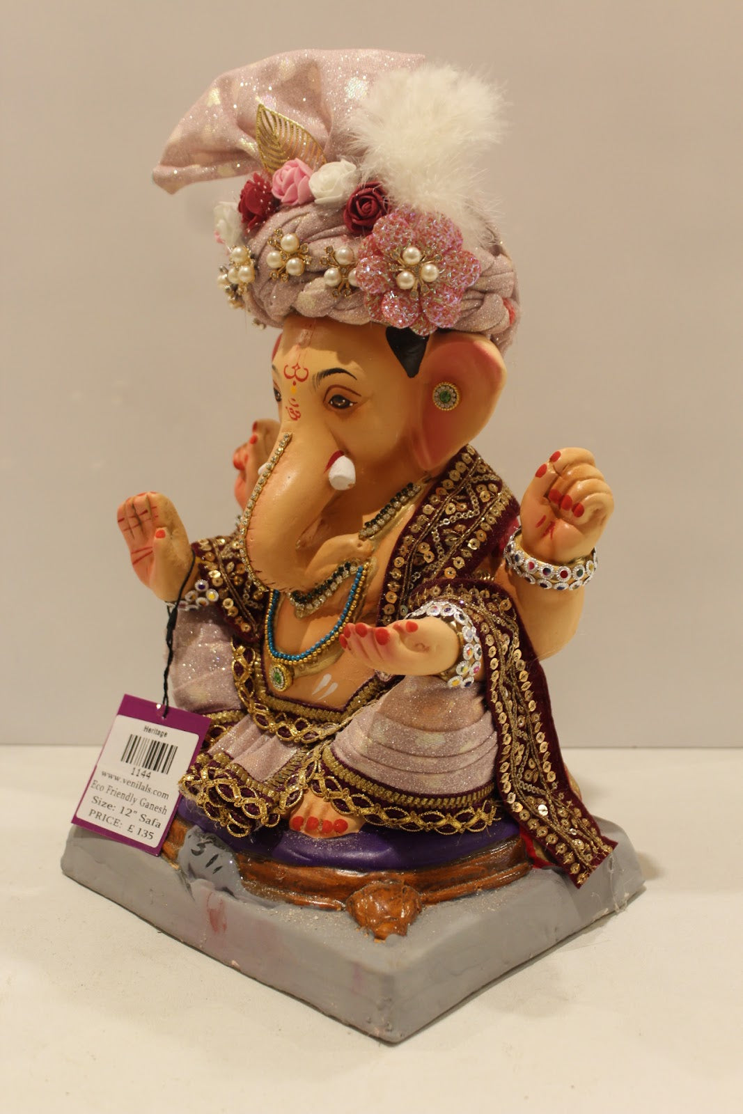 Eco-friendly clay Ganesh idol with blush pink rose safa, side view