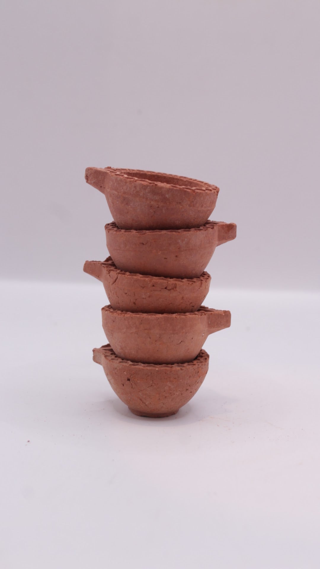 Plain clay diyas stacked