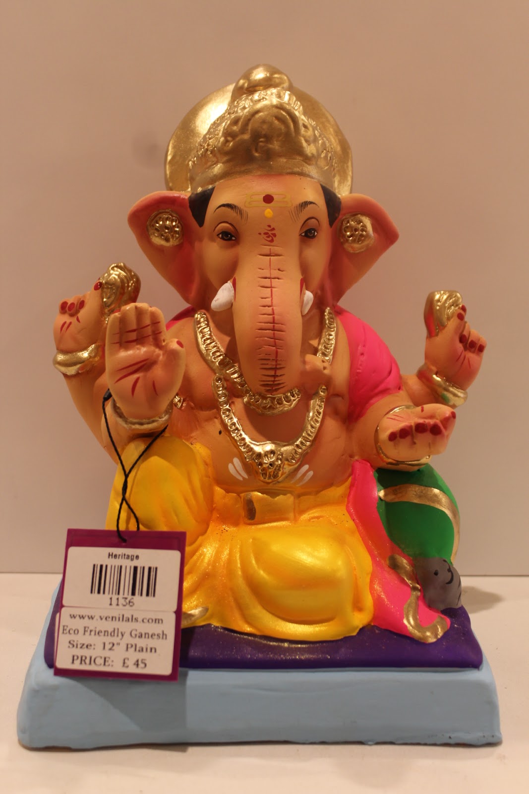 Eco-friendly clay Ganesh idol with pink khes and yellow dhoti, front view