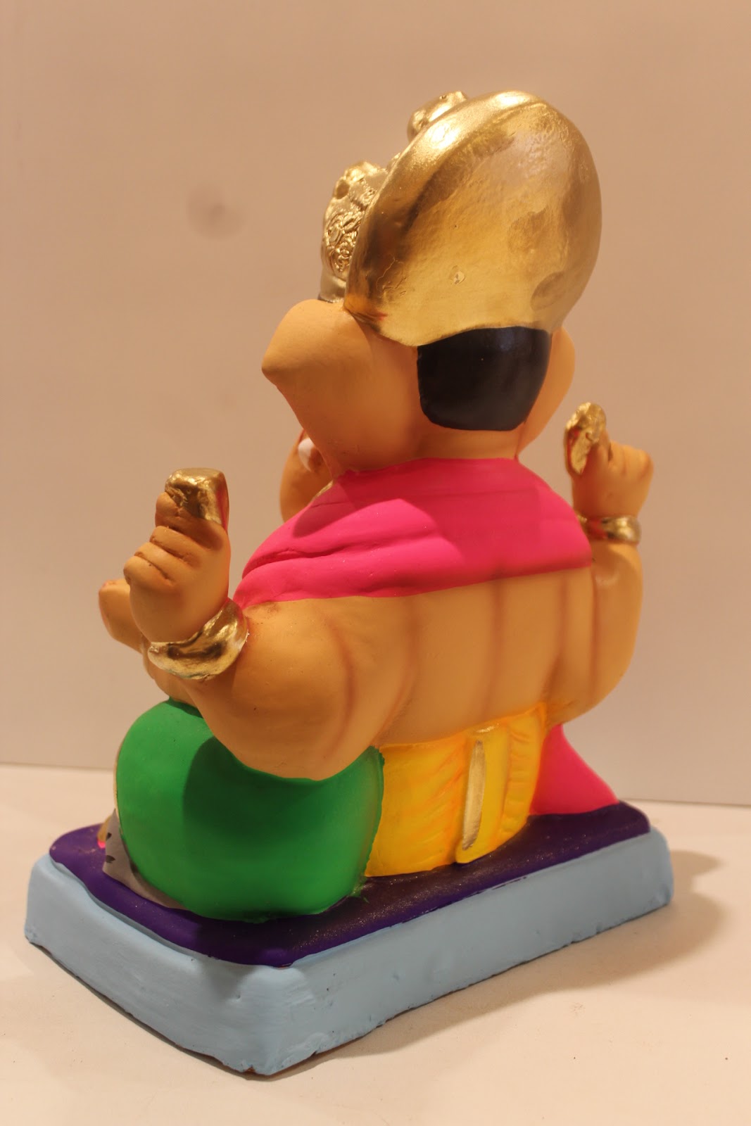 Eco-friendly clay Ganesh idol with pink khes and yellow dhoti, back view