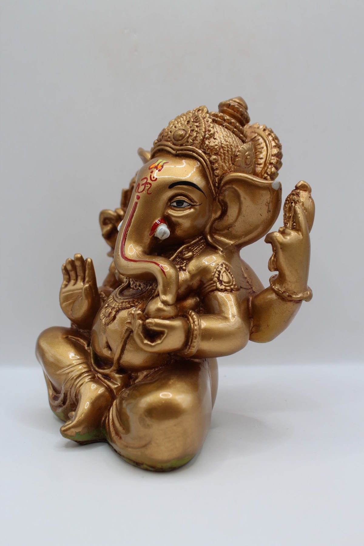 Copper gold resin Ganesh murti seated, right side view