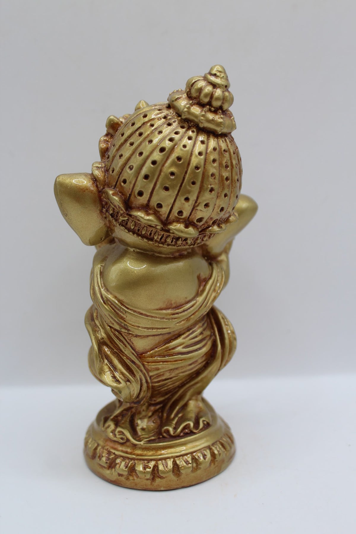 Gold resin Ganesh murti standing, playing flute, back view