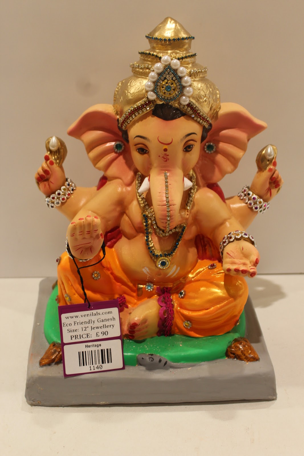 Eco-friendly clay Ganesh idol in jewellery style with pearl and teal crown, front view