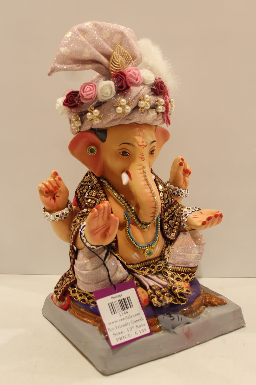 Eco-friendly clay Ganesh idol with blush pink rose safa, side view