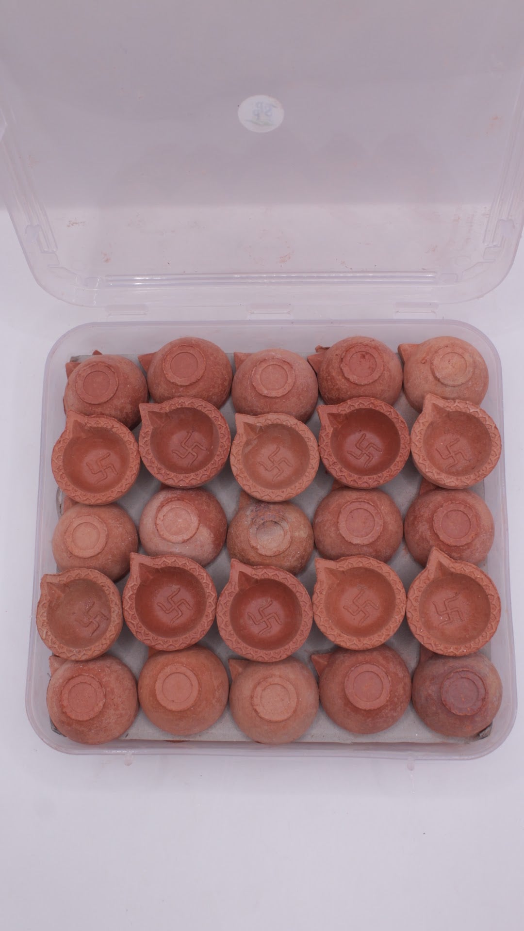 Box of 50 plain clay diyas with swastik, open