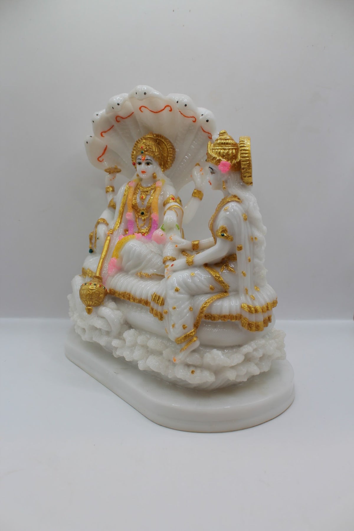 White and gold resin Vishnu Laxmi murti on Sheshnaag, right side view