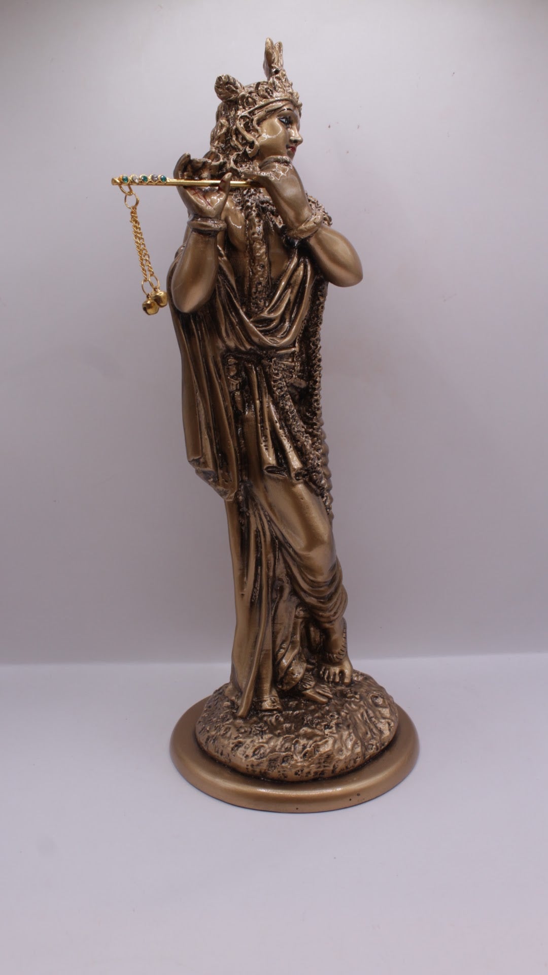 Antique bronze resin Krishna statue playing flute, left side view