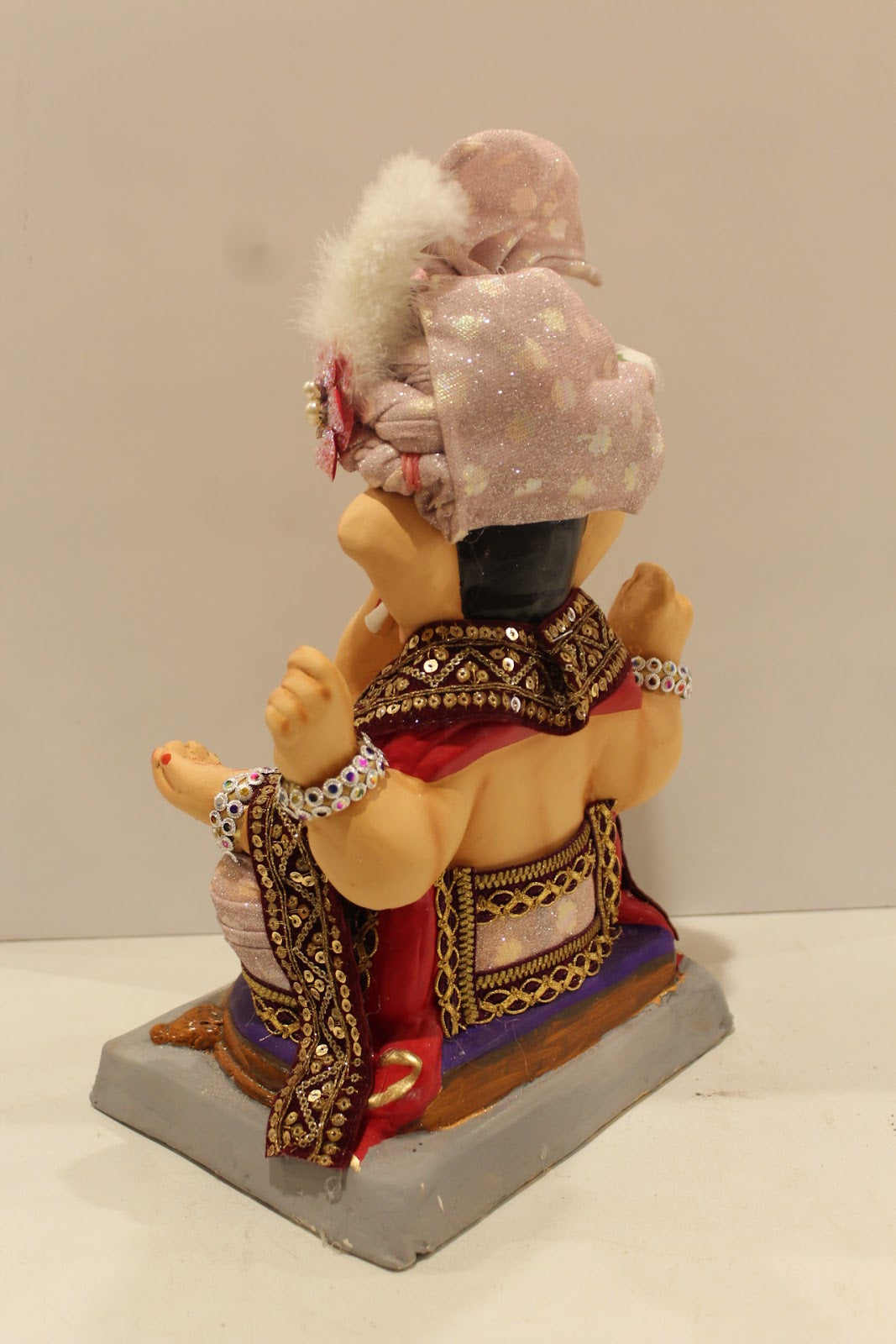 Eco-friendly clay Ganesh idol with blush pink rose safa, back view