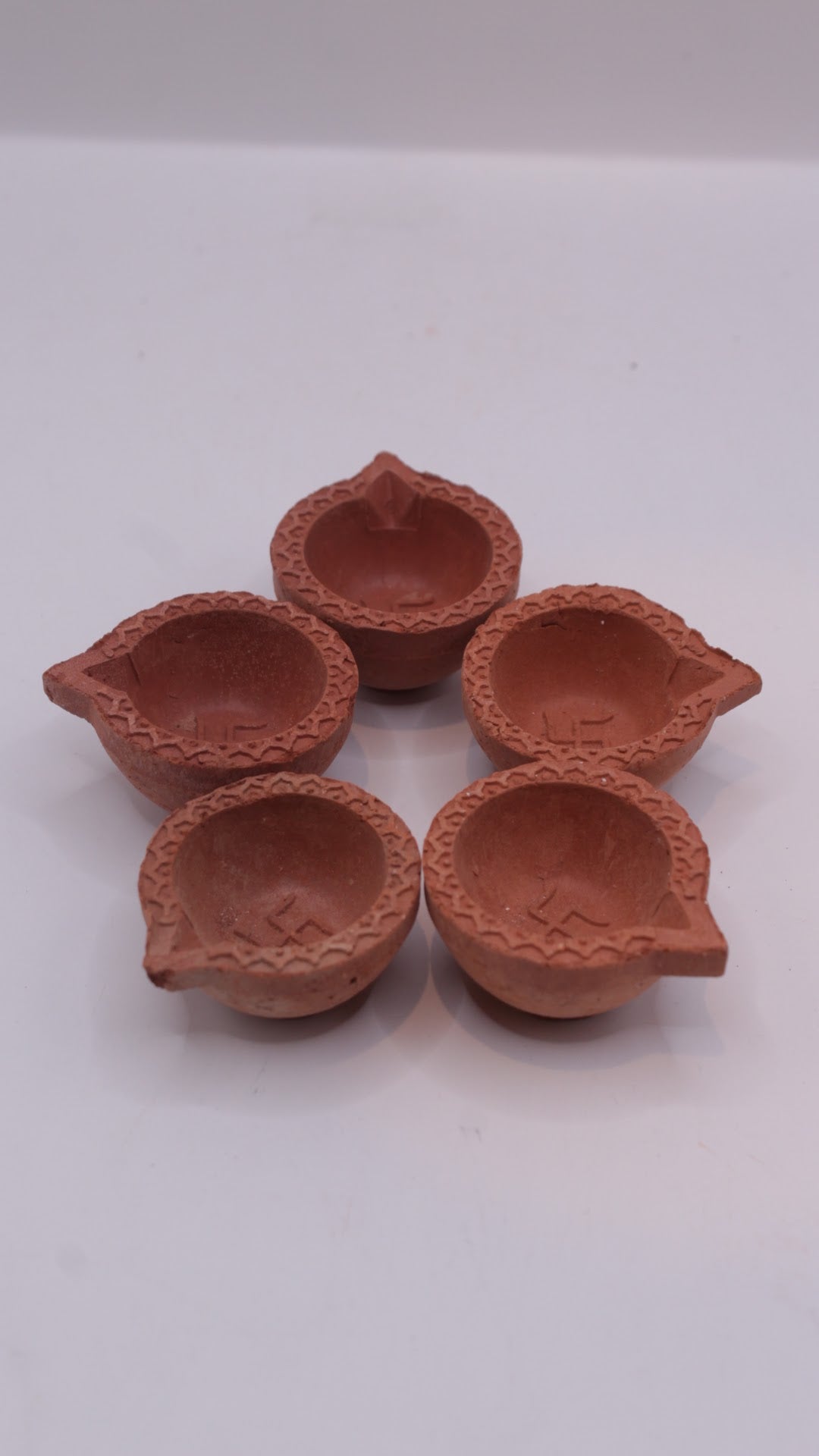 Plain clay diyas, side