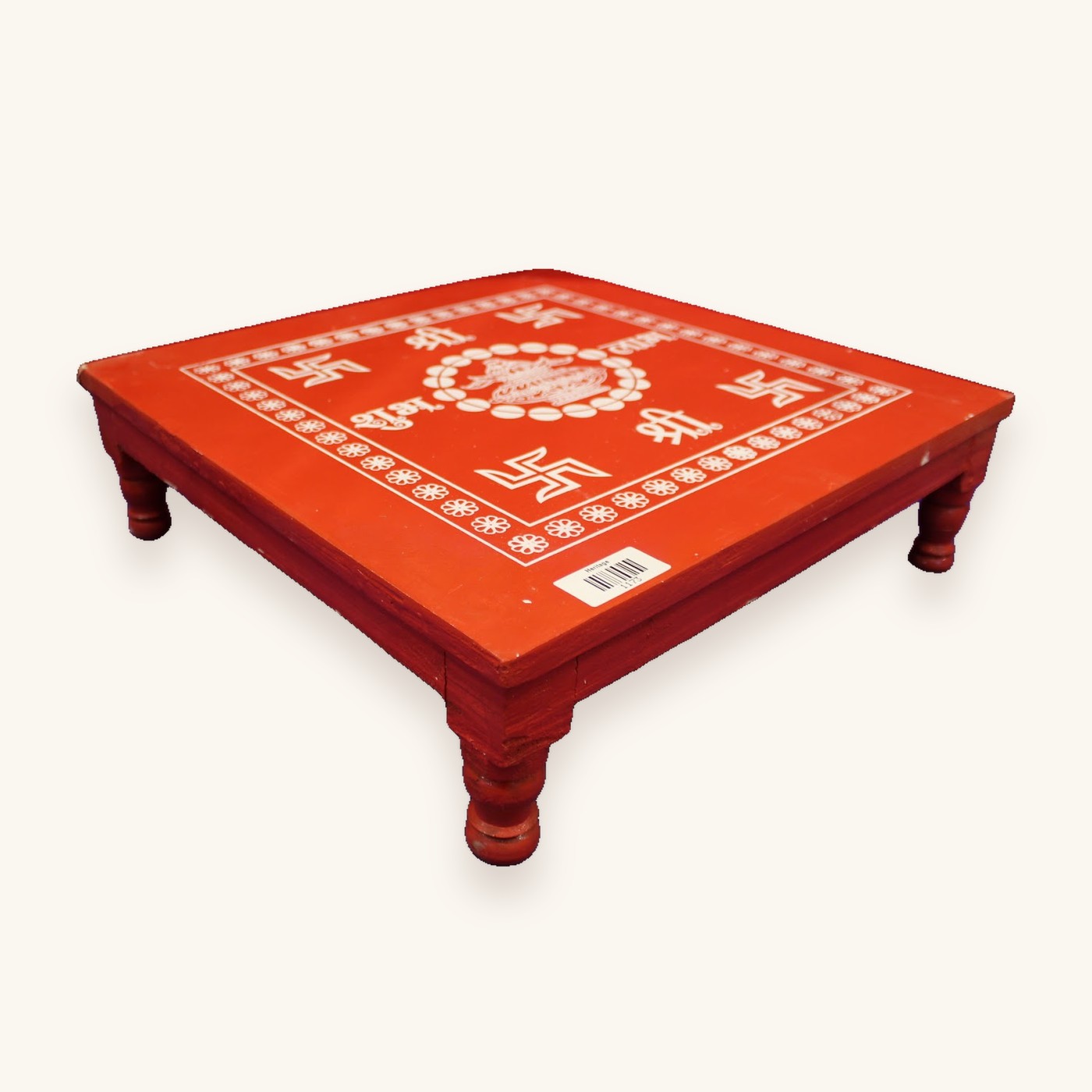 Red wooden bajot with swastik and Shri kalash design, angled view