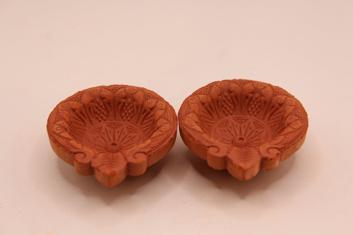 One Face Floral clay diya, front