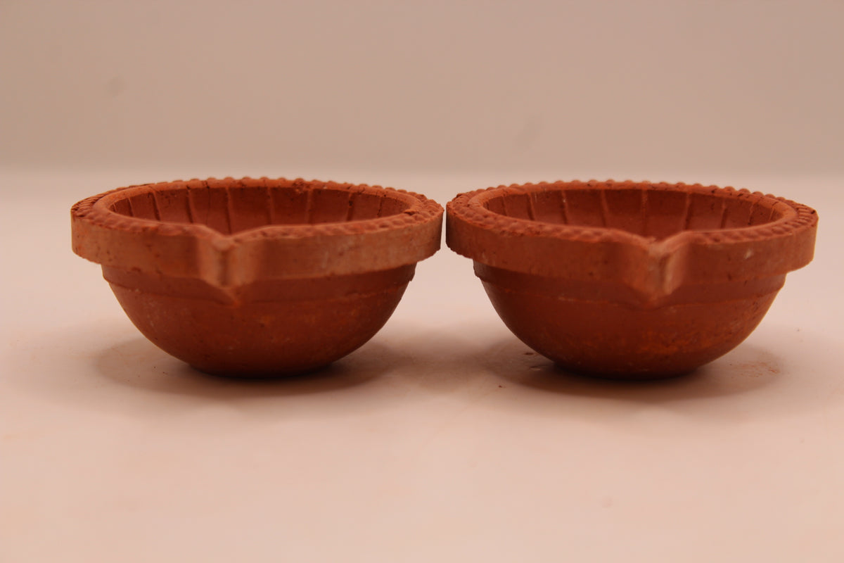 One Face Lined clay diya, left