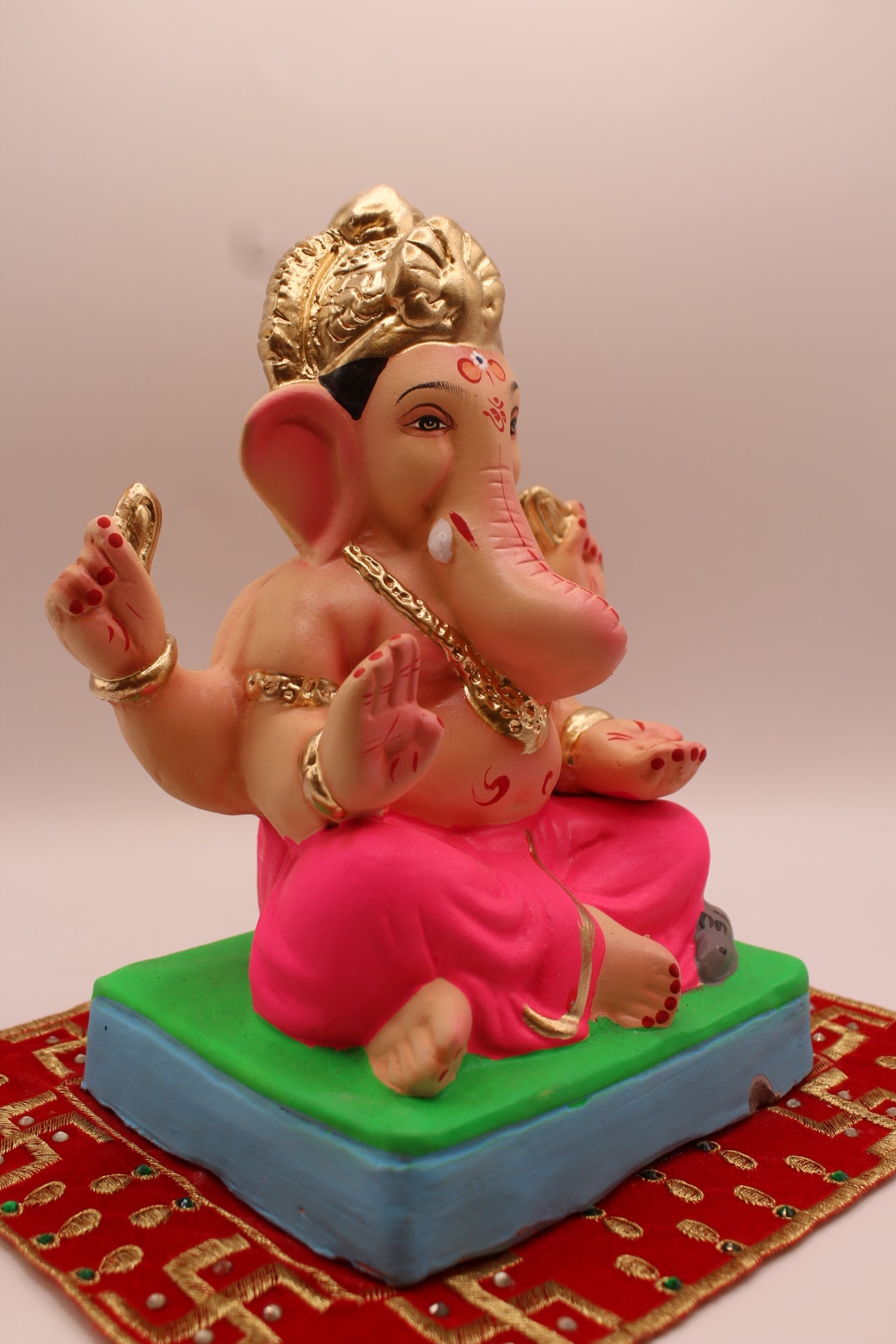 Eco-friendly 8 inch Ganesh Visarjan idol with gold fan crown and rani pink dhoti – side view